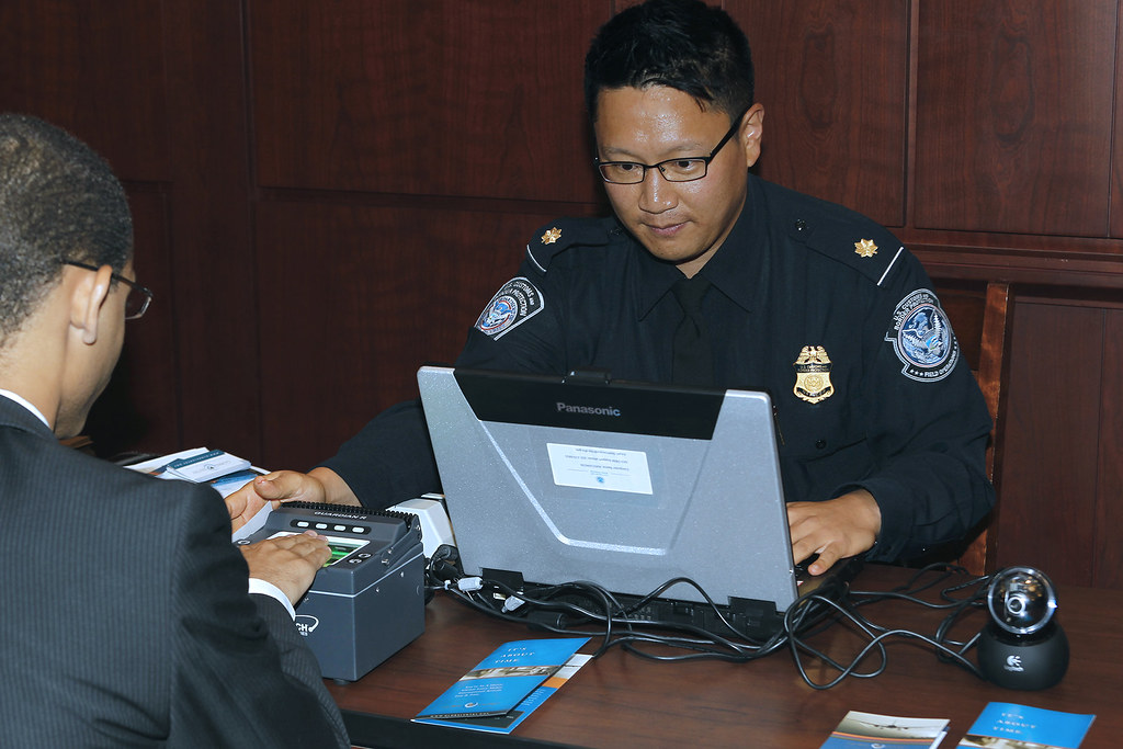 CBP officer capturing a traveler’s fingerprints during a mobile Global Entry interview