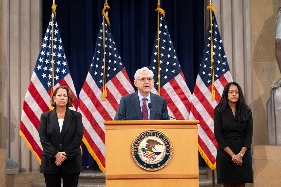 Officials at a formal event in the Justice Department Great Hall in Washington