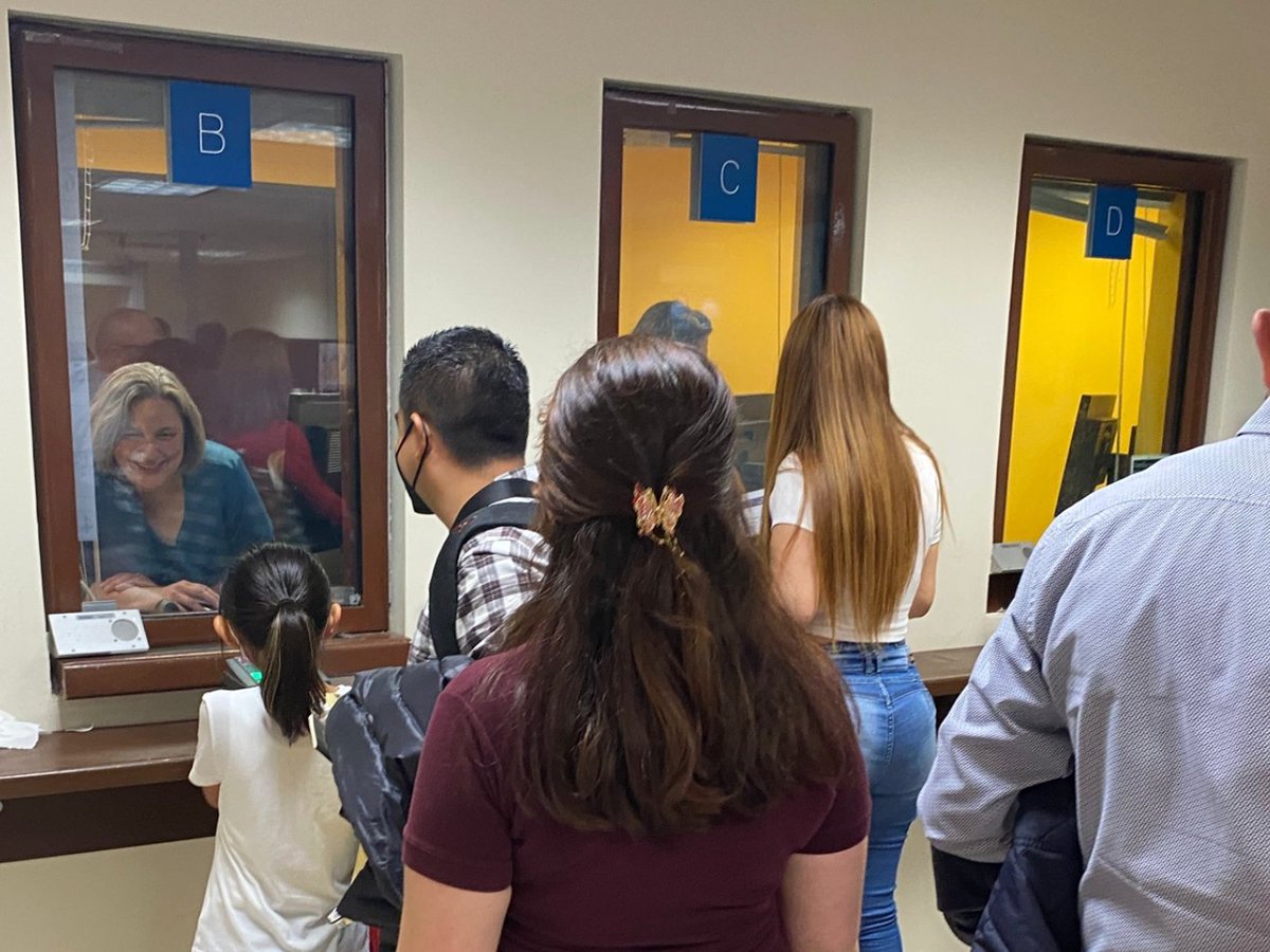 Visa applicants at service windows inside the U.S. Embassy in Mexico