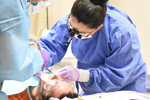 ICE Health Service Corps public health officer providing dental care at a detention facility